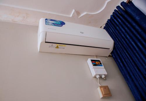 a white printer with an ipod plugged into it at Studio With Lake View in Nkumba
