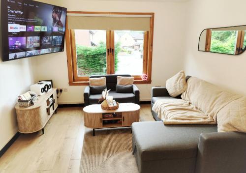a living room with a couch and a table at Dundee Beach Villa with Free Parking in Dundee