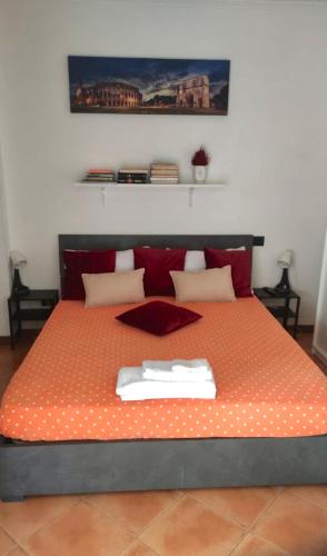 a bedroom with a bed with two towels on it at Appartamento Roma Est in Lunghezza