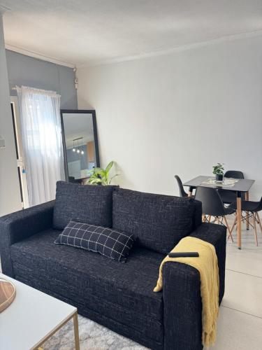 a blue couch in a living room with a table at Fargo in Ongwediva