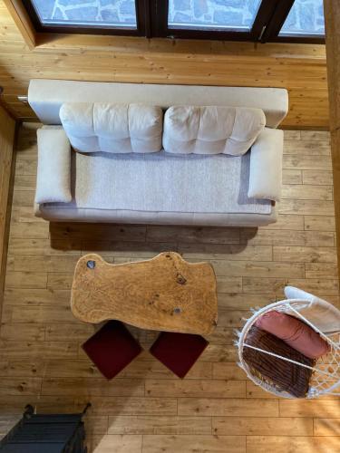 a couch sitting on top of a wooden floor at Skroviste, Zlatibor-Vodice in Zlatibor