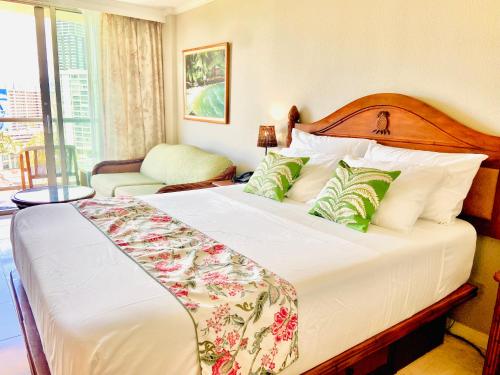 a bedroom with a bed and a room with a window at Luana Waikiki hotel& suites in Honolulu