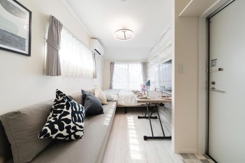 a living room with a couch and a desk at Intervia Horikiri in Tokyo