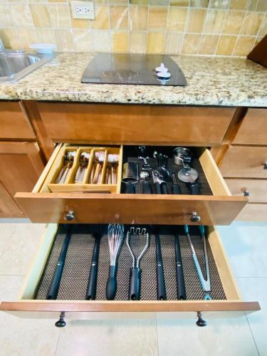 a drawer filled with cooking utensils in a kitchen at Luana Waikiki hotel& suites in Honolulu