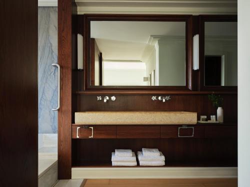 a bathroom with a sink and a mirror at Kontokali Bay Resort & Spa in Kontokali
