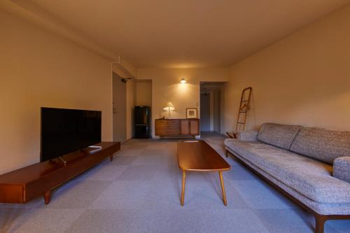 a living room with a couch and a coffee table at Hotel Stelle Belle in Hakuba