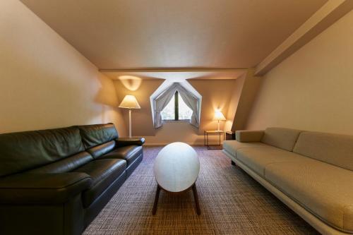 a living room with a couch and a table at Hotel Stelle Belle in Hakuba