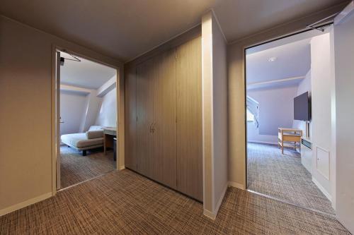 a room with a door leading to a bedroom at Hotel Stelle Belle in Hakuba