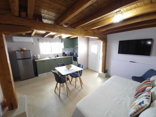 a kitchen with a table and chairs in a room at RAVANIS Home in Áyios Pétros