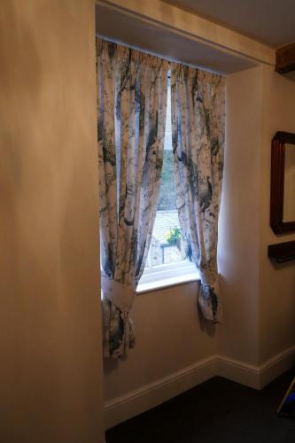 a window with curtains in a room at The Victoria in Malham