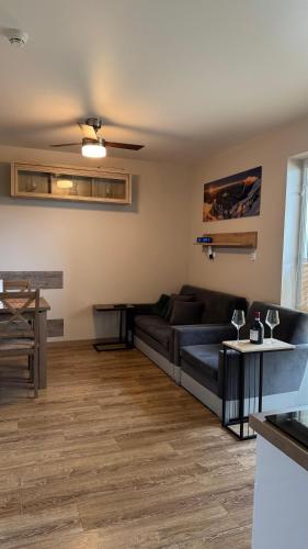 a living room with a couch and a table at Apartamenty MonteVerde w Świeradowie-Zdroju in Świeradów-Zdrój