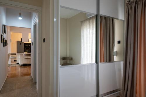 a living room with a large mirror in a room at Central Luxury Penthouse in Kalamata