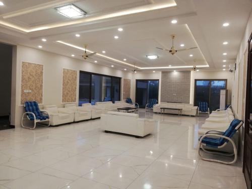 a large lobby with couches and chairs in a building at KHALIL SONs FARM HOUSE in Dargai