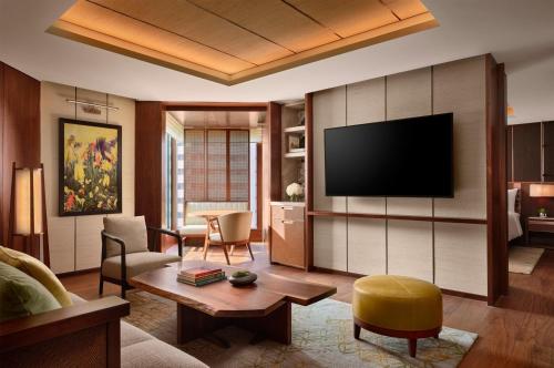 a living room with a couch and a tv at Grand Hyatt Singapore in Singapore