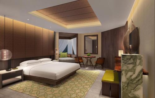 a bedroom with a bed and a living room at Grand Hyatt Singapore in Singapore
