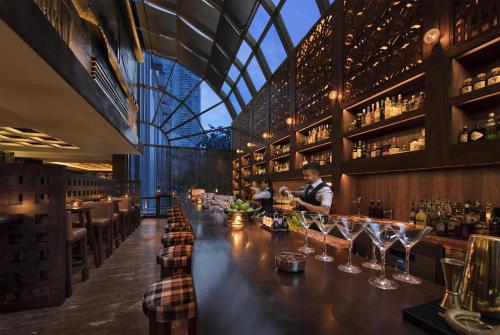 a bar in a restaurant with people in the background at Grand Hyatt Singapore in Singapore