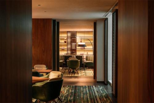 a living room with chairs and a dining room at Grand Hyatt Singapore in Singapore