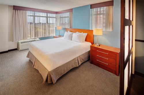 a large bed in a hotel room with two windows at Hyatt Place Madison/Downtown in Madison