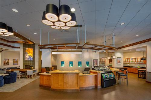 a lobby with a restaurant with tables and chairs at Hyatt Place Madison/Downtown in Madison