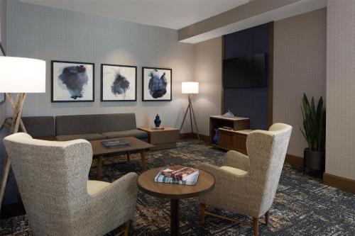 a living room with chairs and a couch and a table at Hyatt Place Salt Lake City Downtown / The Gateway in Salt Lake City