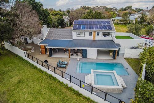 an aerial view of a house with a solar roof at The Otters Oarsman Stanford Riverside Retreat in Stanford