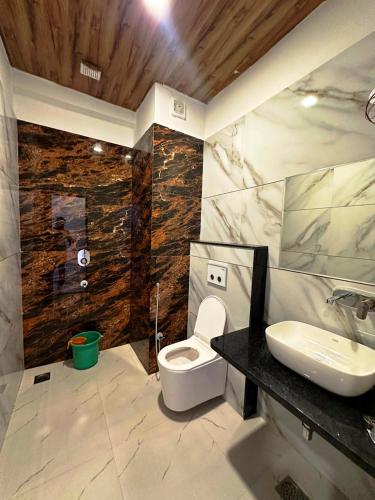 a bathroom with a white toilet and a sink at Horizon Resort Pushkar-Feel of The Nature in Pushkar