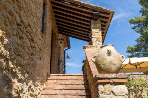 a statue of a face on the side of a building at Podere del Botruccio in Pomarance