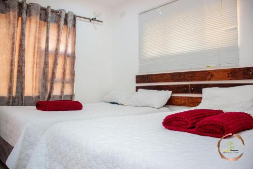 Ένα ή περισσότερα κρεβάτια σε δωμάτιο στο Crestly Resorts Nyanga