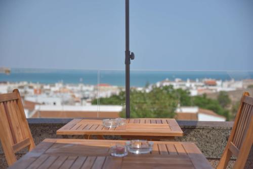 a wooden table sitting on top of a beach at Lagos Uptown Bed & Breakfast in Lagos