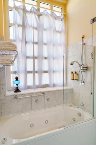 a bath tub in a bathroom with a window at Hotel San Luca in Spoleto