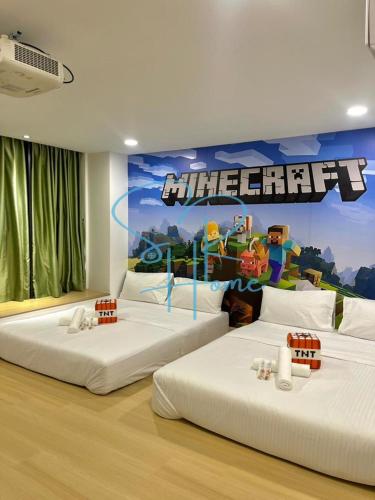 two beds with a video game mural on the wall at Sunway GRID by SR Home in Kampong Pendas