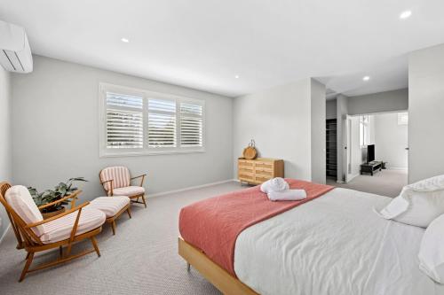 a bedroom with a large bed and two chairs at Saltwater in Anglesea