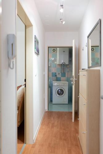 a bathroom with a washer and dryer in a room at Tartini Residence - Fully Furnished Apartment in Piran