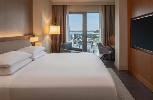 a hotel room with a bed and a flat screen tv at Hyatt Regency Lake Washington at Seattle's Southport in Renton