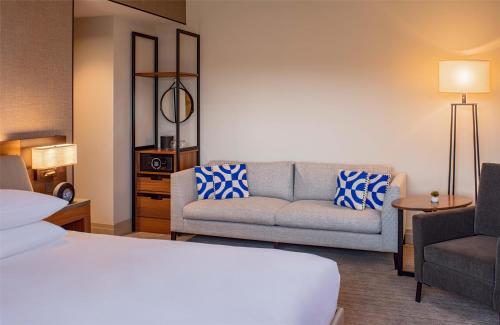 a hotel room with a bed and a couch at Hyatt Regency Lake Washington at Seattle's Southport in Renton