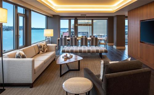 a living room with a couch and a tv at Hyatt Regency Lake Washington at Seattle's Southport in Renton