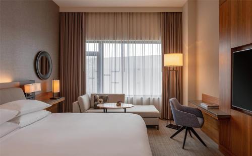 a hotel room with a bed and a tv at Hyatt Regency Lake Washington at Seattle's Southport in Renton