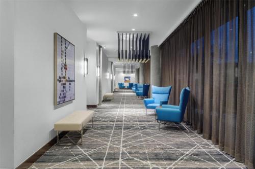 a corridor of a hospital with blue chairs at Hyatt Place Athens Downtown in Athens