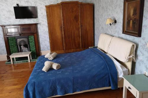 a bedroom with a bed with two towels on it at Villa Melina Hotel in Kalymnos