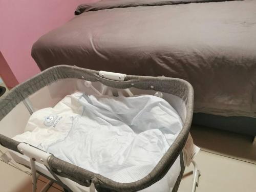 a baby crib next to a bed in a room at Ryokan AI Japan Friend - Free Hotsprings & Massage in Kuala Lumpur