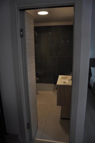 a bathroom with a shower and a sink and a mirror at B&B la cruna deLago in Omegna