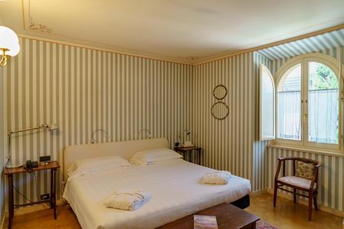 a bedroom with a bed with two towels on it at Hotel San Luca in Spoleto