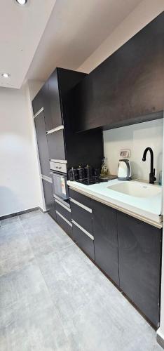 a kitchen with a sink and a counter top at Sea Of Galilee 118 in Tiberias