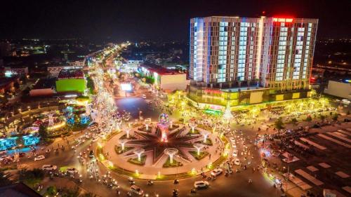 a city at night with a clock in the middle at Sophia Center - Serviced Apartment - Duke Hospitality in Rach Gia