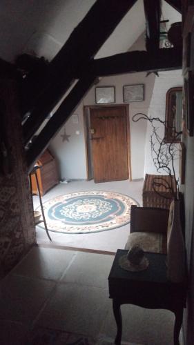 a bedroom with a large bed with a wooden door at LE VIEIL HERMITAGE in Ervauville
