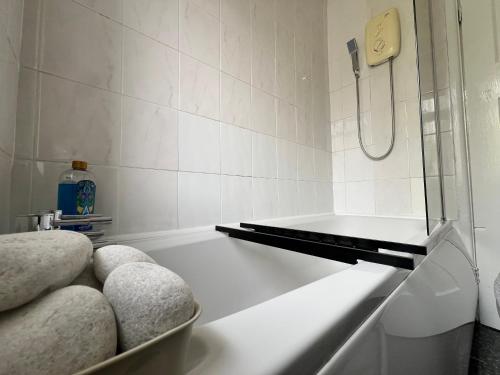 a bathroom with a shower and a bath tub at Budget Spacious 3 bed home in manchester in Manchester