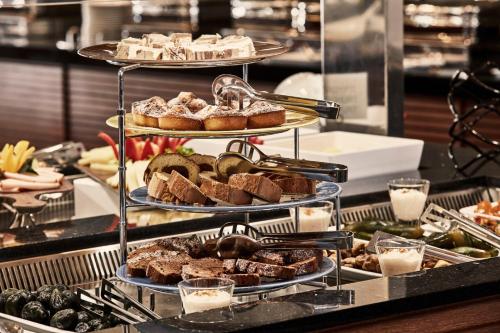 a three tiered display of pastries and breads on a buffet at Kontokali Bay Resort & Spa in Kontokali
