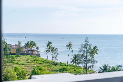a house on a hill next to the ocean at Maris Beach Hotel Phu Quoc in Phu Quoc