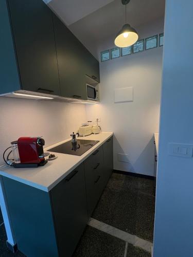 a kitchen with a sink and a red appliance on a counter at Il terrazzino sul Golfo in Recco