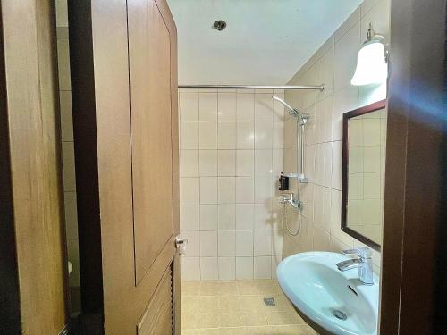 a bathroom with a sink and a mirror at CEO Flats in Manila